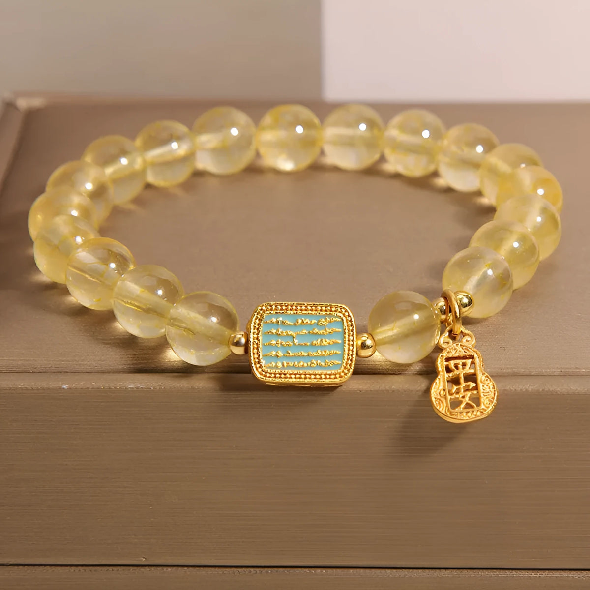 Women's yellow citrine crystal bracelet with rhinestone detailing on wrist