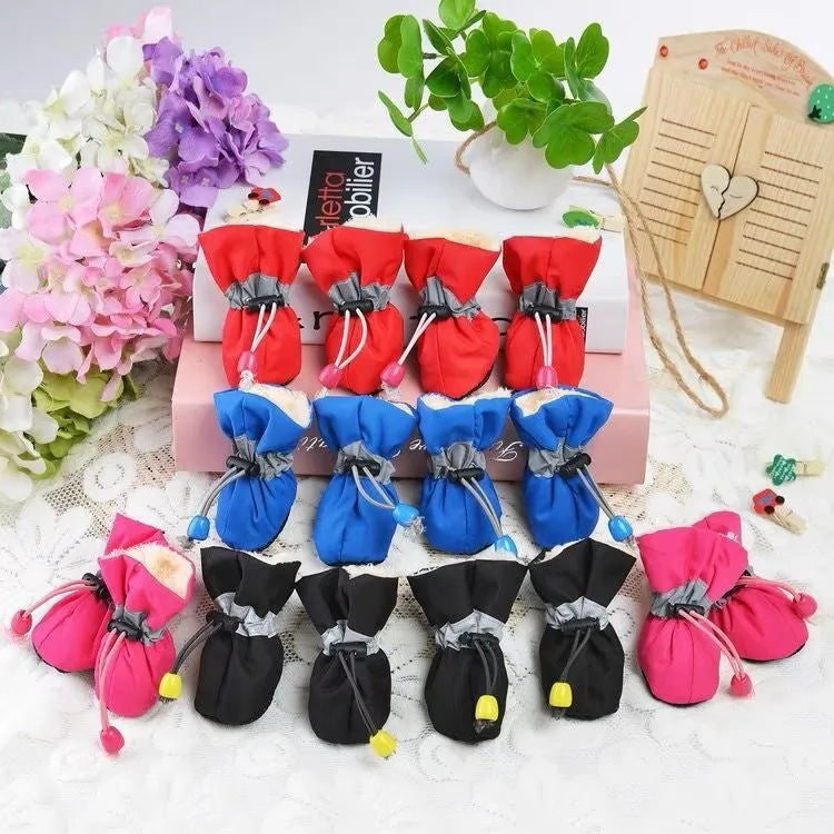 Cloth dog shoes with soft soles in multiple colours including red, black, blue, and monkey print designs