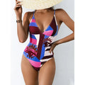 Plus size solid blue one-piece swimsuit with a backless design on a mannequin.