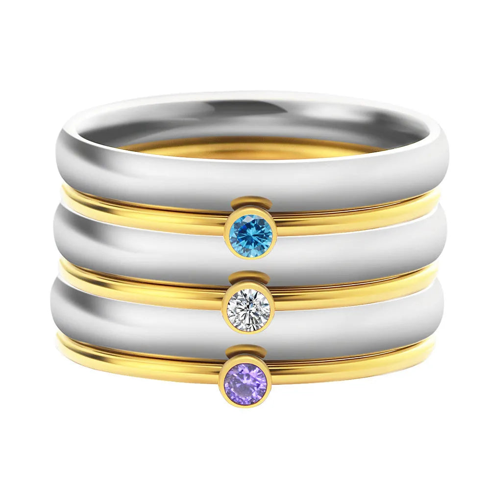 December birthstone geometric engraved ring in titanium steel on a grey background.