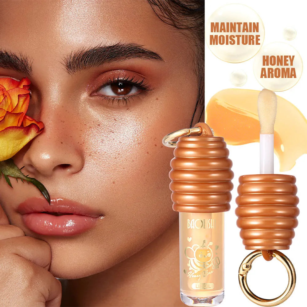 Portable honey lip gloss with keychain attached to bag strap