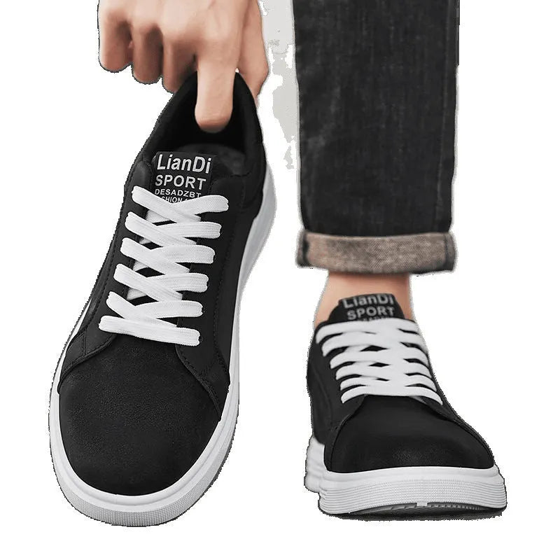 Men's black snake pattern leather low-top sneakers with round toe and flat rubber sole.