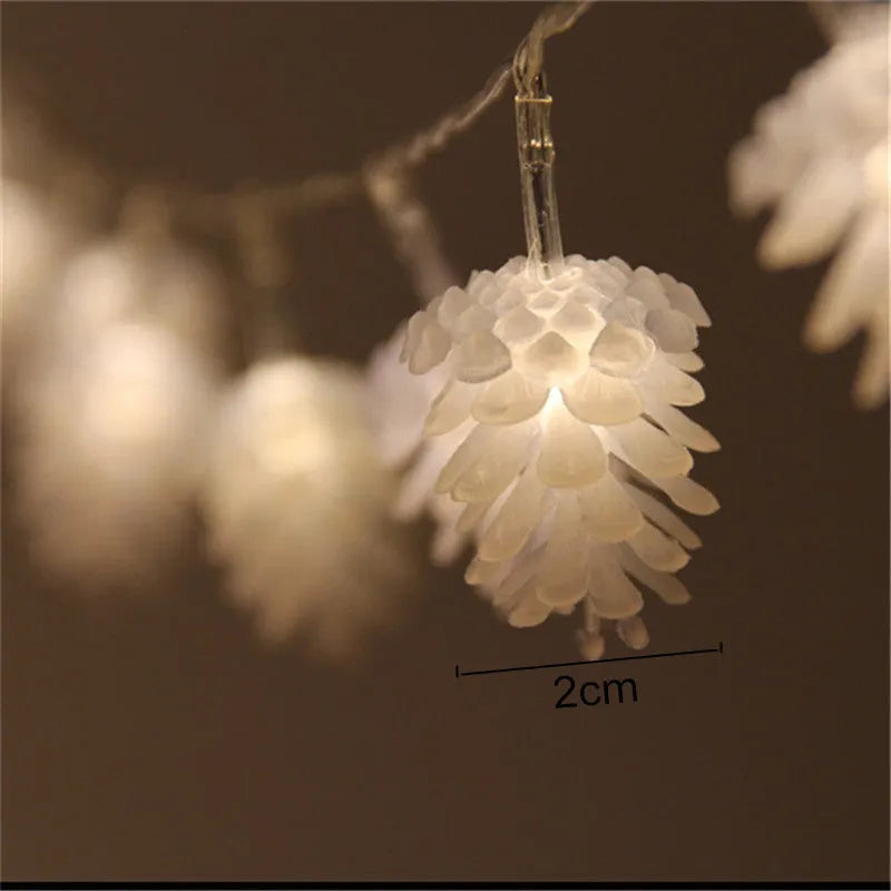 Warm white LED pine cone decorative light string powered by two AA batteries.