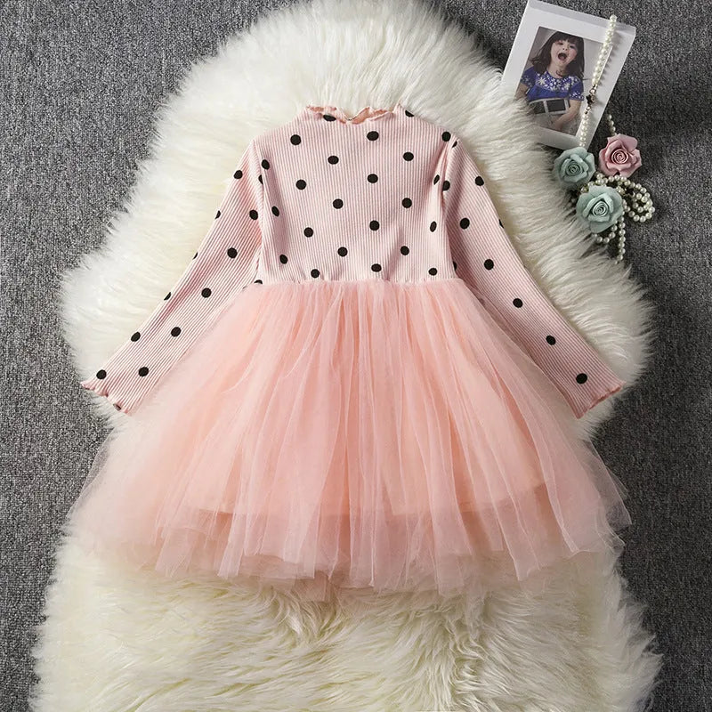 Baby girl wearing a long sleeve white lace tutu dress for a birthday party