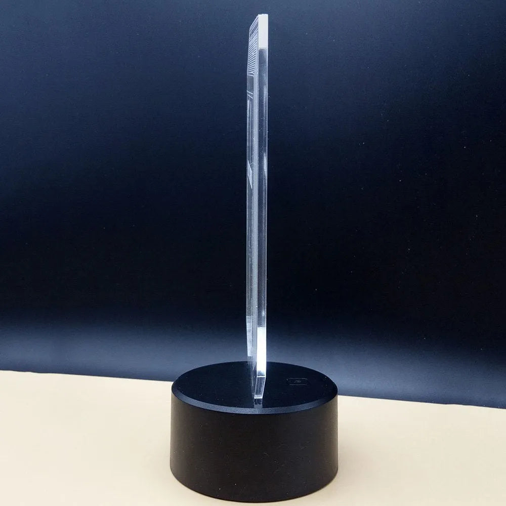 3D acrylic illusion desk lamp with colour-changing LEDs and a black ABS base on a wooden surface.