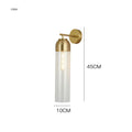 Nordic minimalist glass wall lamp in smoke grey colour mounted on a light wall.