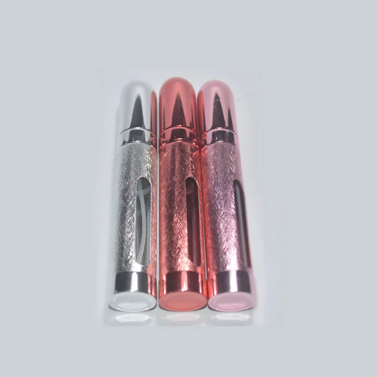 Slim 12ml aluminium travel perfume bottle with glass liner in choice of six colours including blue, gold, and pink.
