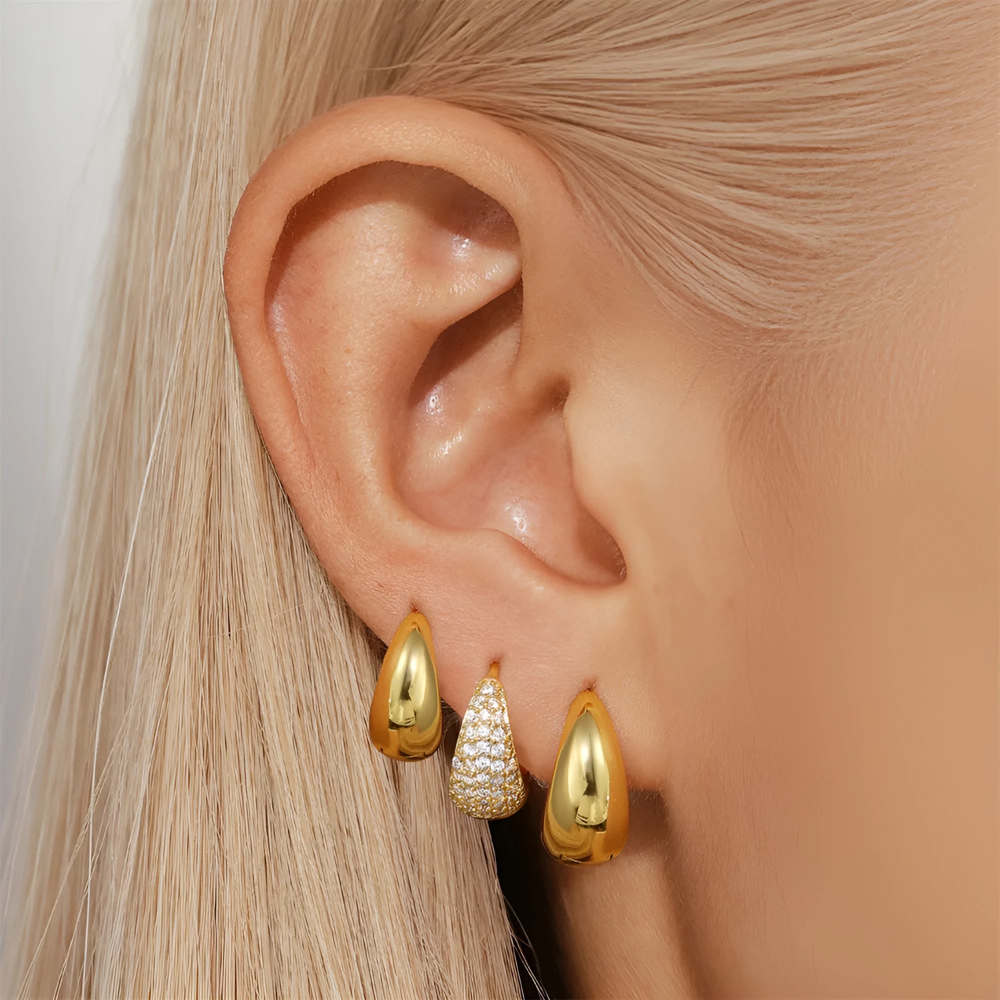 A pair of simple round geometric brass earclip earrings with a gold electroplated finish.