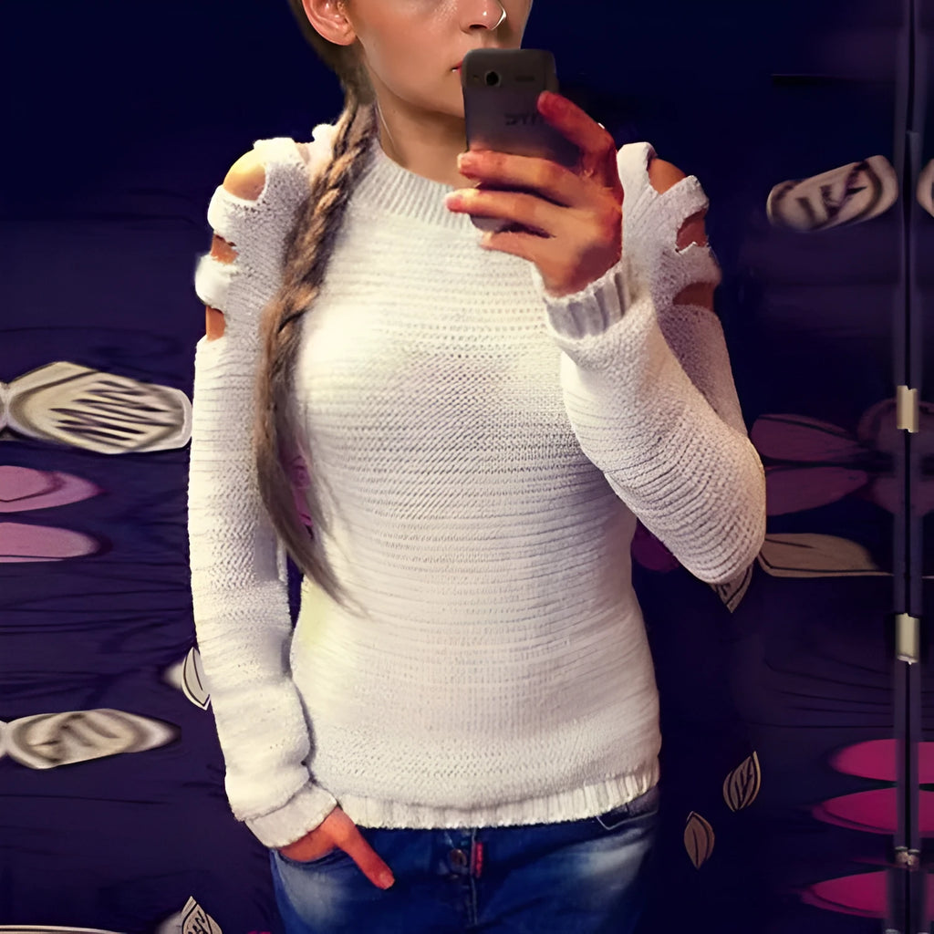 Women's grey hollow out knitted pullover top with round neck and long sleeves laid flat.