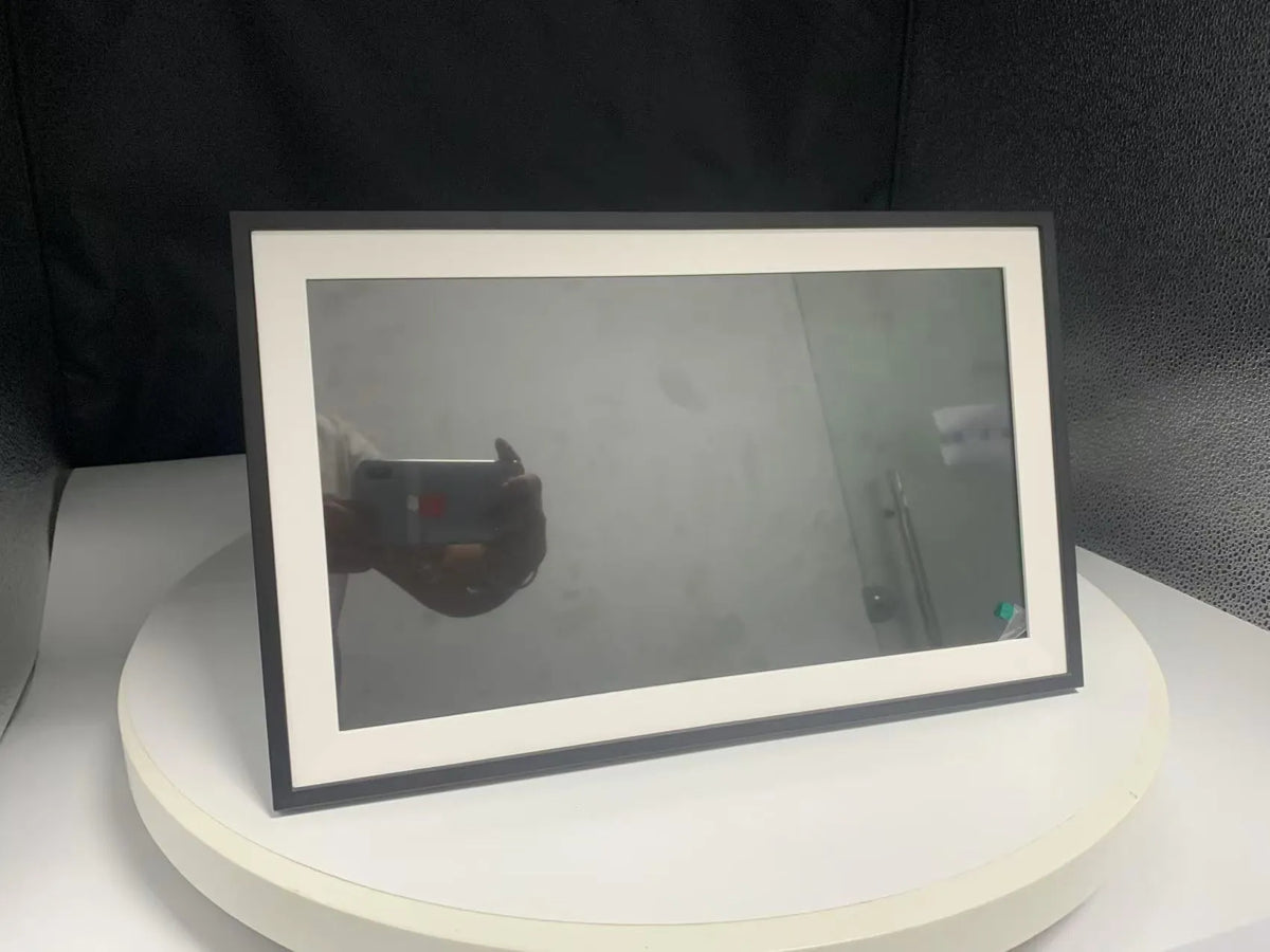 White 15.6 inch smart digital photo frame showing family photographs on Full HD display