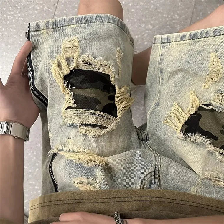 Men's yellow camouflage denim shorts with distressed rips and straight leg cut