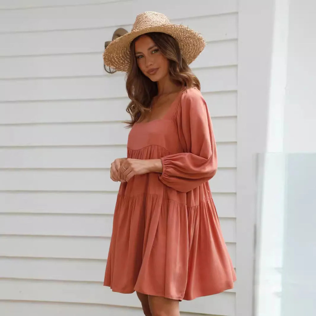 Girls orange backless dress with puff sleeves and a square collar, showing A-line skirt.