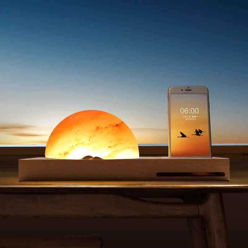 Natural crystal salt lamp on a beech wood base with integrated wireless phone charging pad.