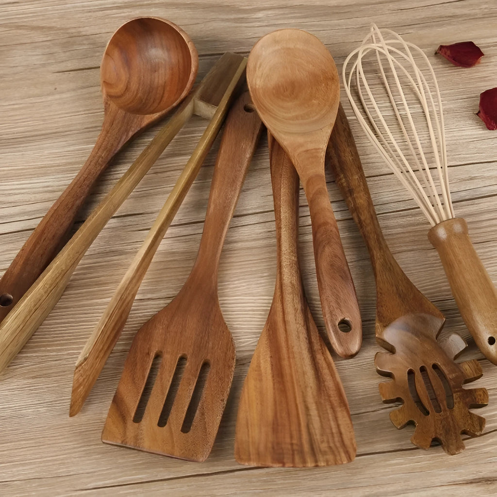Seven wooden cooking utensils arranged together showing different shapes and sizes