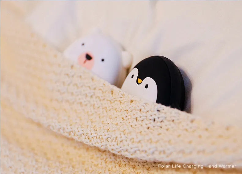 USB rechargeable electric hand warmer with penguin polar bear design showing front and back heating surfaces