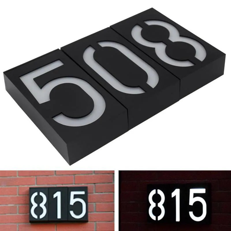 Solar powered outdoor house number lamp with white LED light and IP65 waterproof rating on a wall.