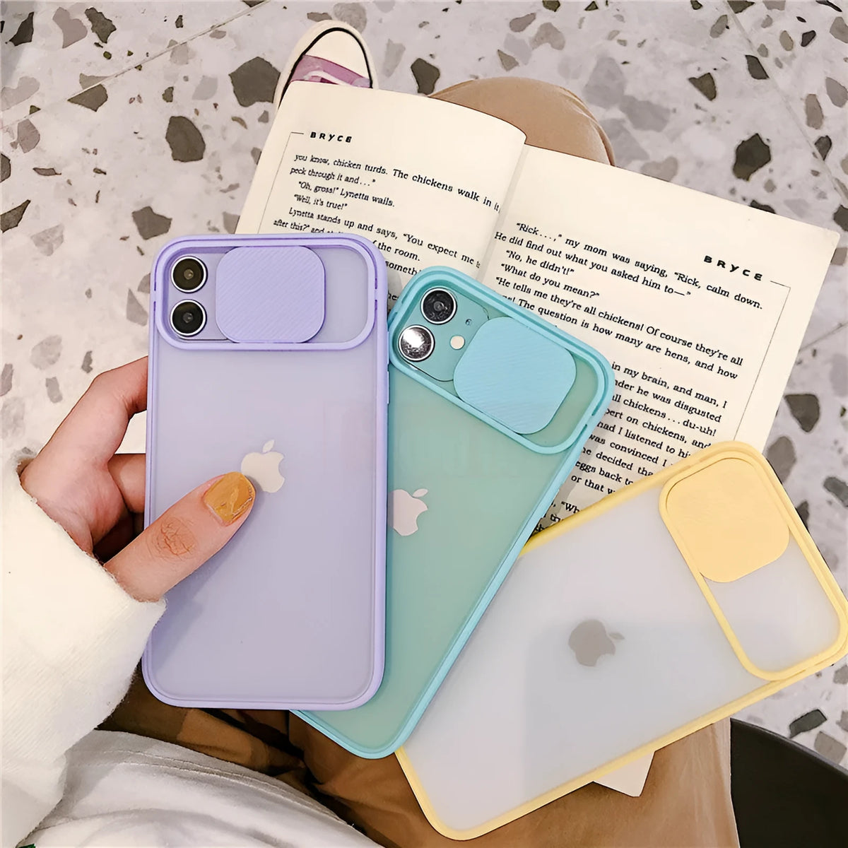 Silicone iPhone case with frosted frame around camera lens in solid colour options like black, blue, pink, and yellow.
