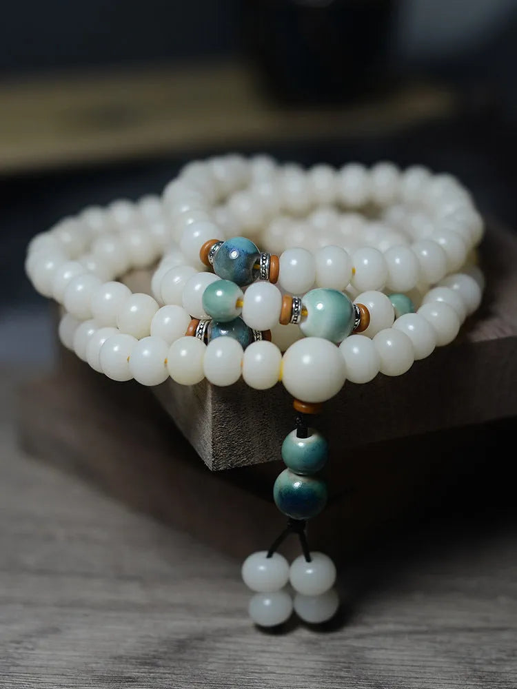 White Jade Bodhi Root bracelet with 108 flat round beads, shown in two size options.