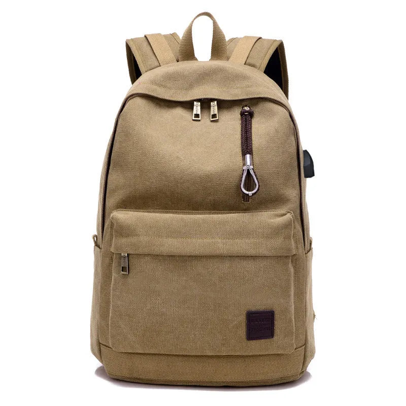 Canvas backpack in grey colour showing USB charging port, front zipper pocket, and adjustable shoulder straps