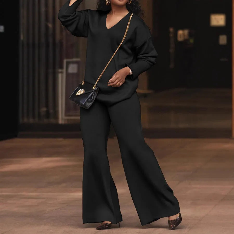 Brown women's suede velvet two-piece suit with long sleeves and full-length trousers on a model.