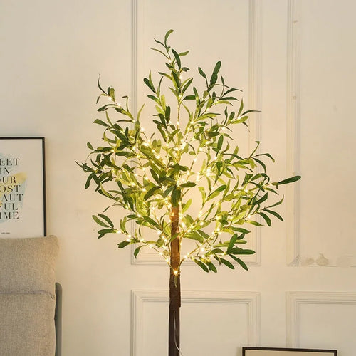 1.8 metre tall artificial olive leaf tree lamp with warm white LED lights illuminated in garden setting