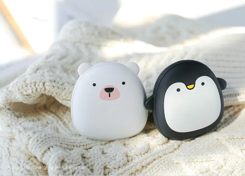 USB rechargeable electric hand warmer with penguin polar bear design showing front and back heating surfaces