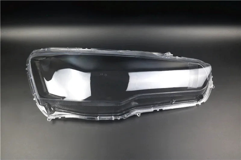 Transparent plastic headlight housing cover for car lighting replacement measuring 50x30x20mm