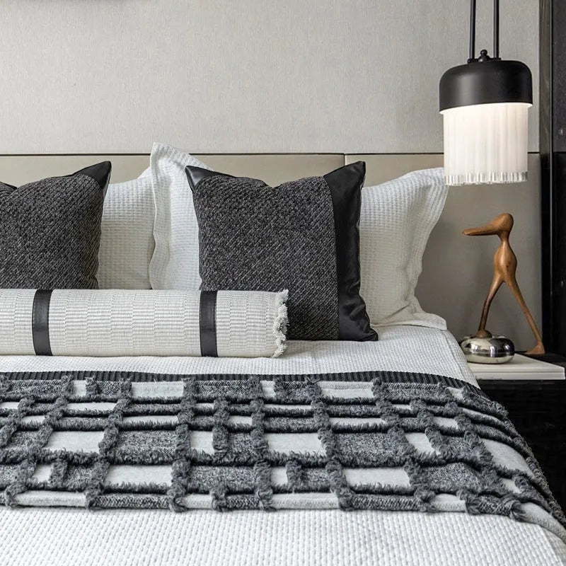 Modern minimalist bed runner set with blanket, pillowcase and leather round pillow on bed