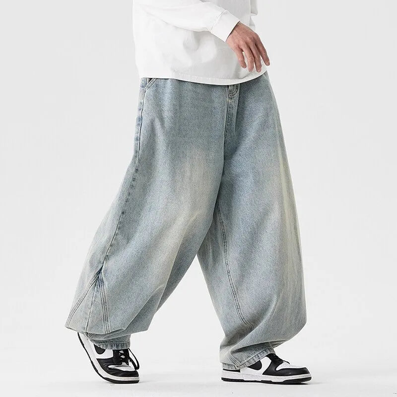 Men's plus size baggy jeans in dark blue denim with a straight leg opening and low waist.
