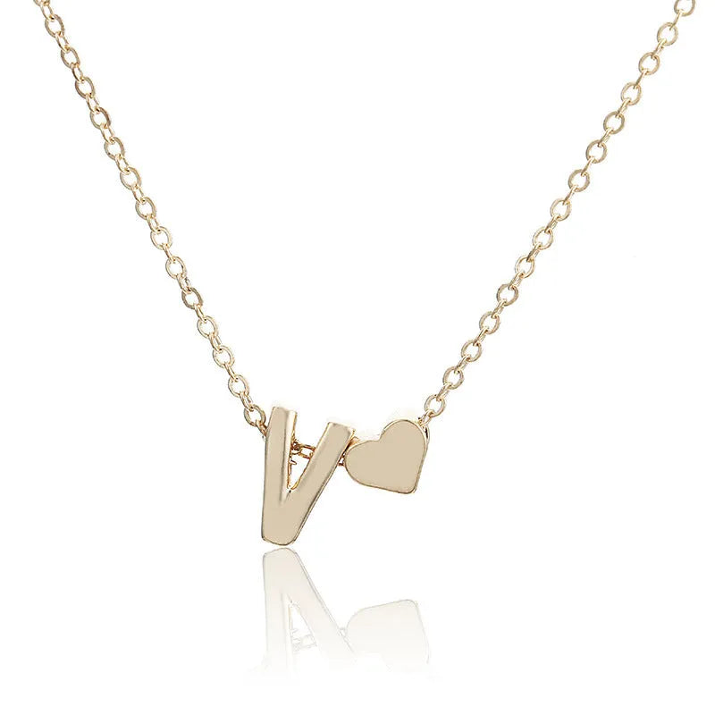 Peach-shaped heart letter pendant necklace on a chain in a gold or silver alloy finish.