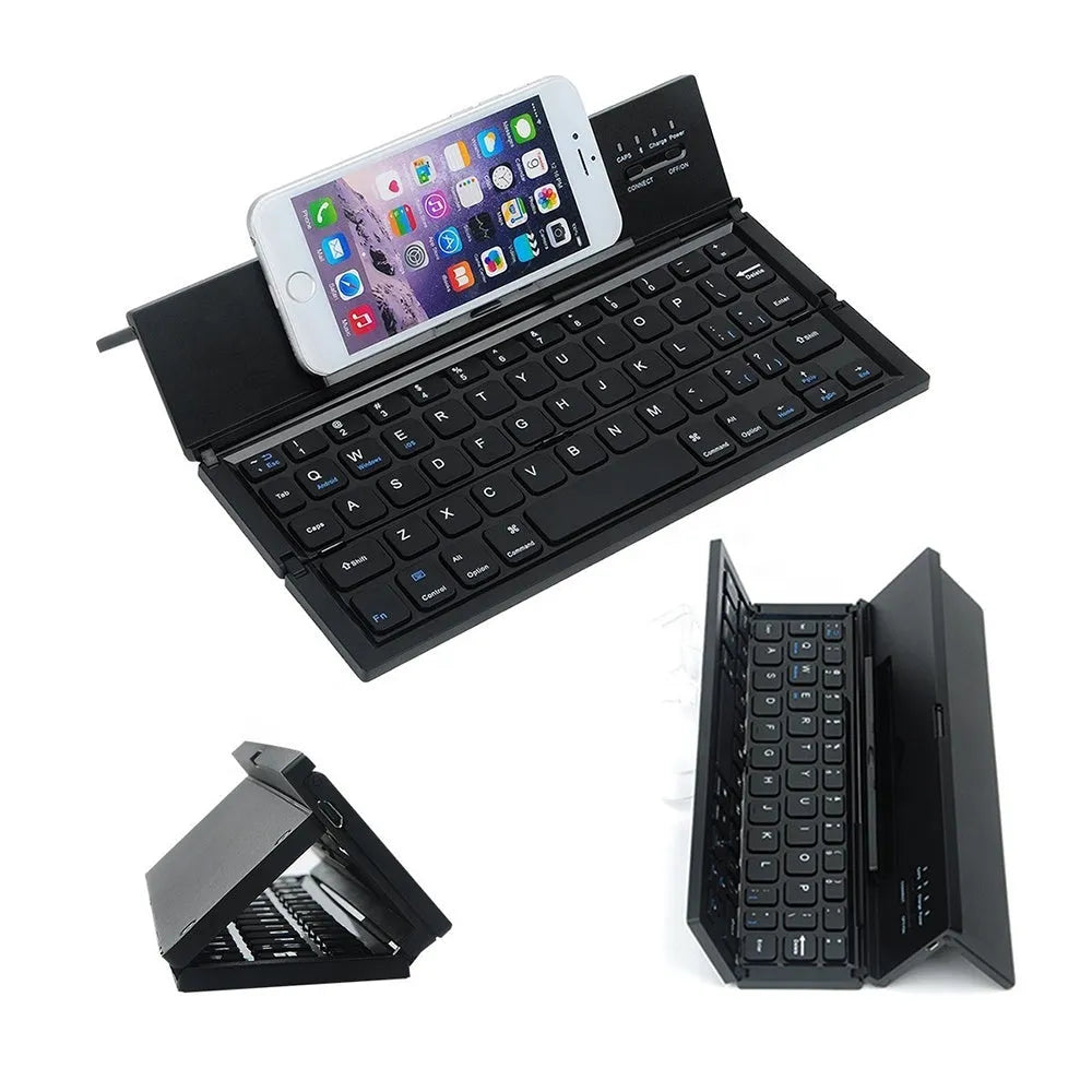 Black folding Bluetooth keyboard unfolded next to tablet showing ultra-thin design