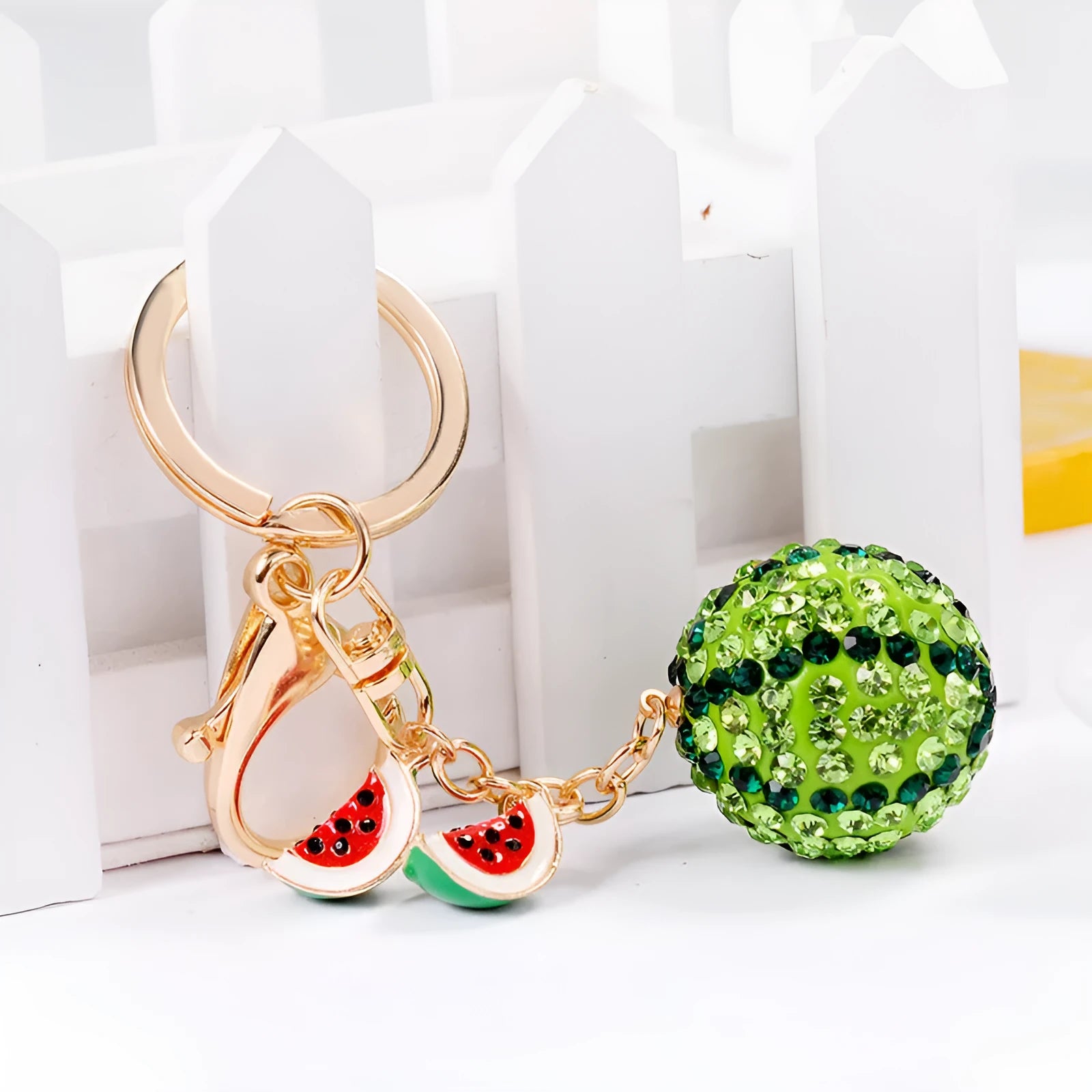 Green watermelon shaped zinc alloy keychain measuring 12cm in length