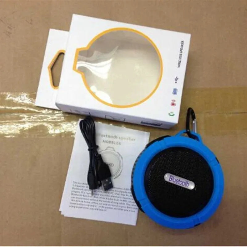 Portable waterproof Bluetooth speaker in multiple colours with a built-in carabiner clip for bags.