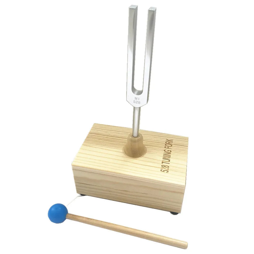Aluminium alloy 432 Hz tuning fork with a matching speaker unit on a kraft paper box.