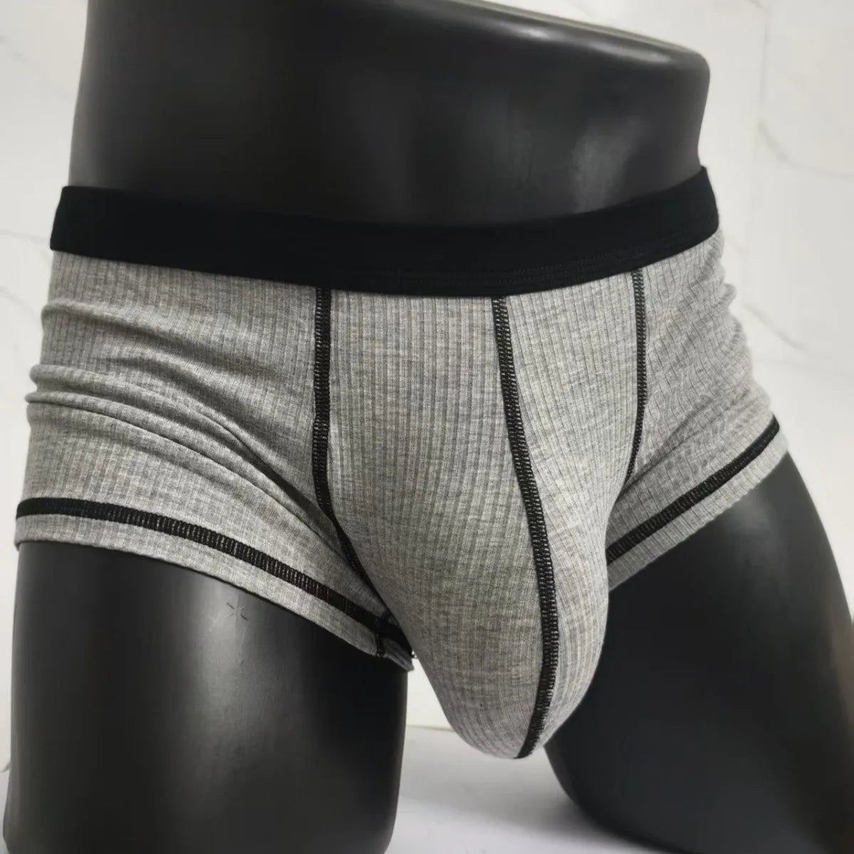 Men's solid colour boxers showing hip lifting and body shaping design in breathable fibre fabric
