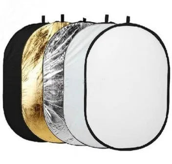 A large, rectangular collapsible photography light reflector showing its five different coloured surfaces: gold, silver, white, black, and translucent.