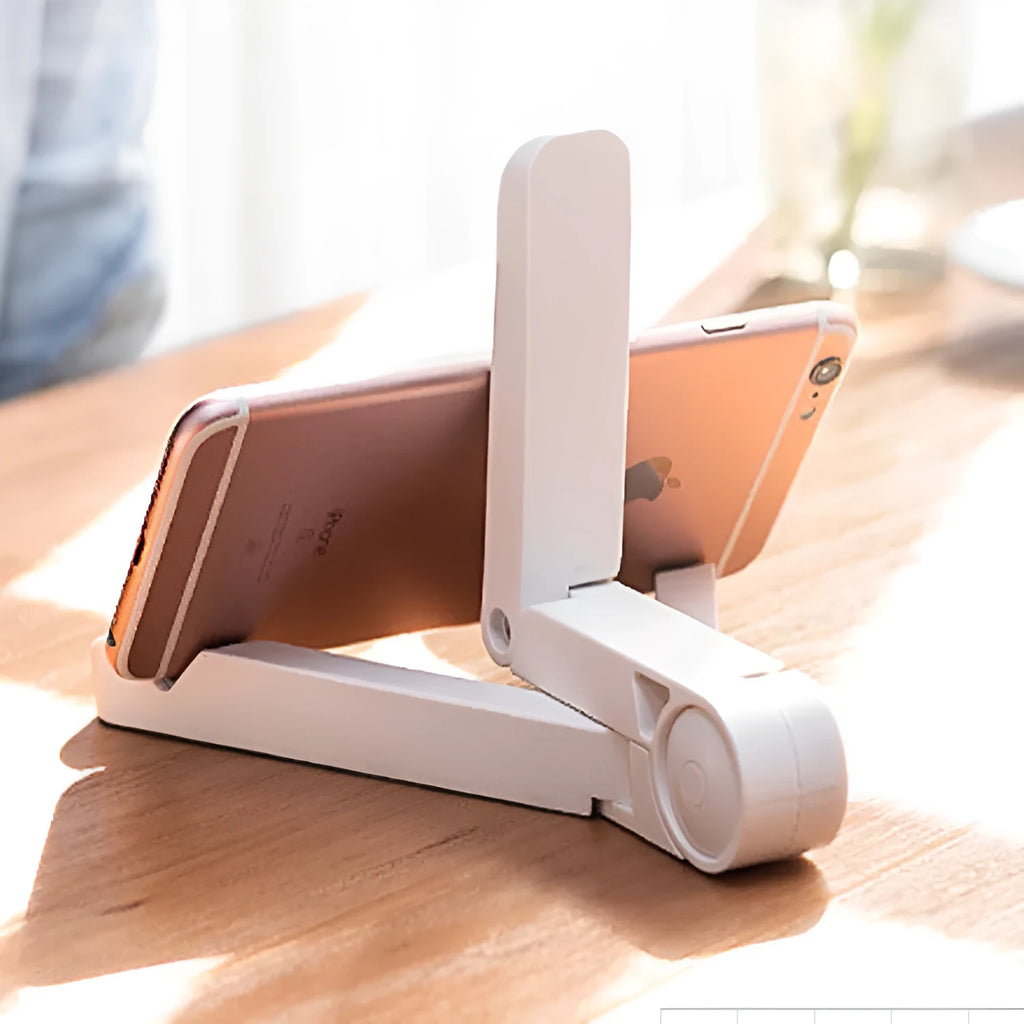 Black foldable tablet holder displaying smartphone at adjustable angle on desk