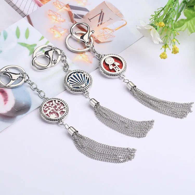 Alloy tassel car pendant with long chain hanging, showing decorative box detail.