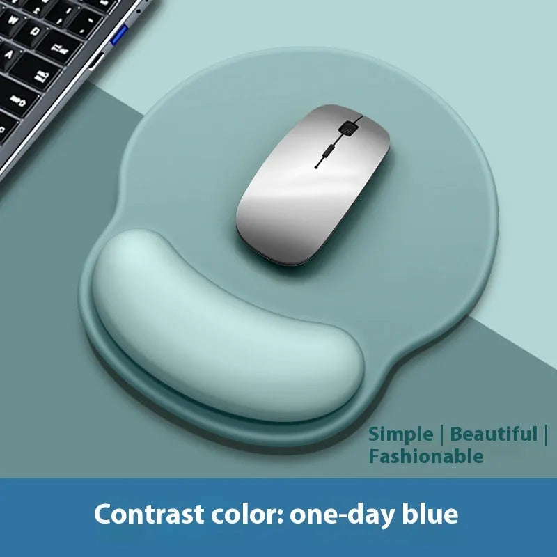 Silicone mouse mat with raised wrist rest in a gradient colour design on a desk.