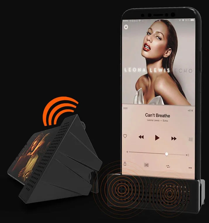 Pink portable ABS mobile phone amplifier bracket holding a smartphone horizontally on a desk.