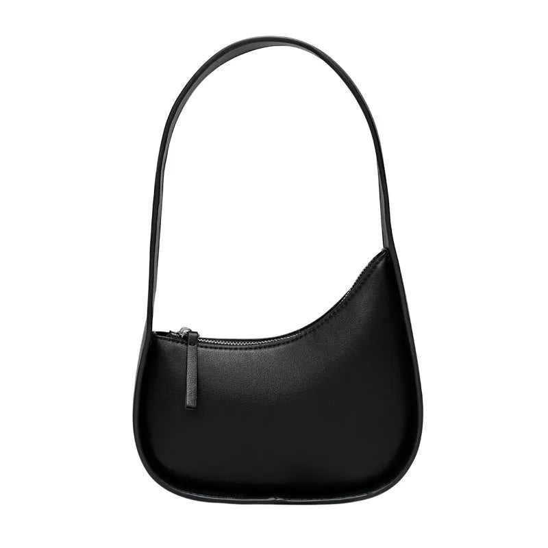Small half-moon shaped leather ladies handbag with wide shoulder strap and zip opening