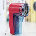 Portable electric lint remover device in selected colour with compact handheld design