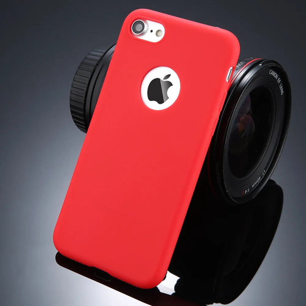 Plain soft silicone TPU phone case for iPhone in a candy colour on a table.