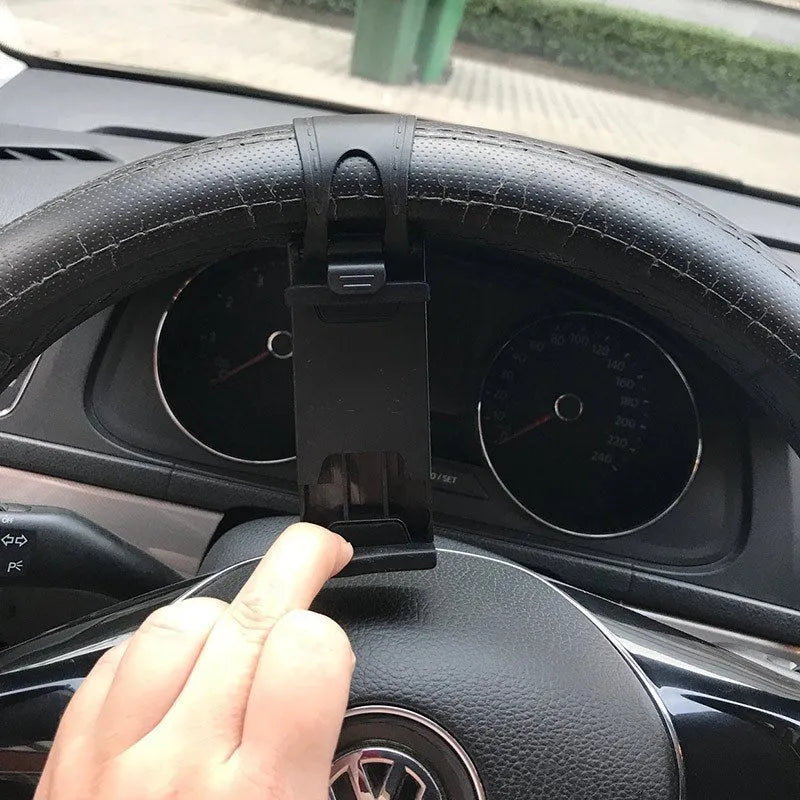 Black steering wheel phone holder mounted showing elastic clip and silicone phone padding