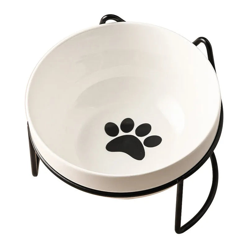 White ceramic cat bowl with decorative iron frame in cat footprints pattern