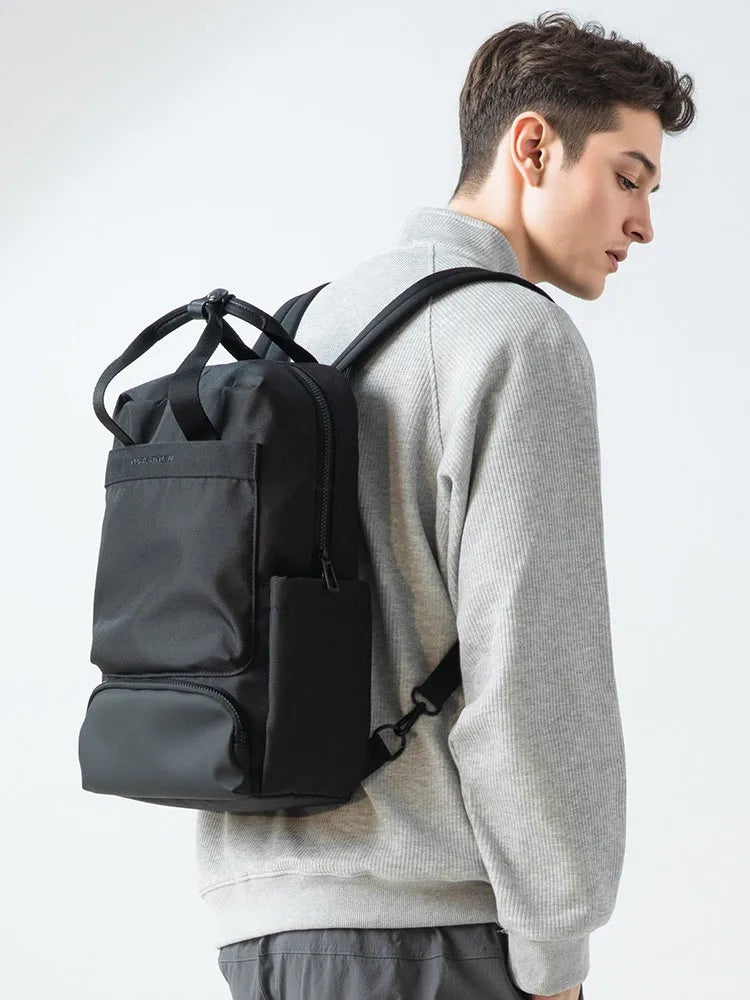 Black oxford cloth computer backpack with multiple compartments showing 20-35 litre capacity