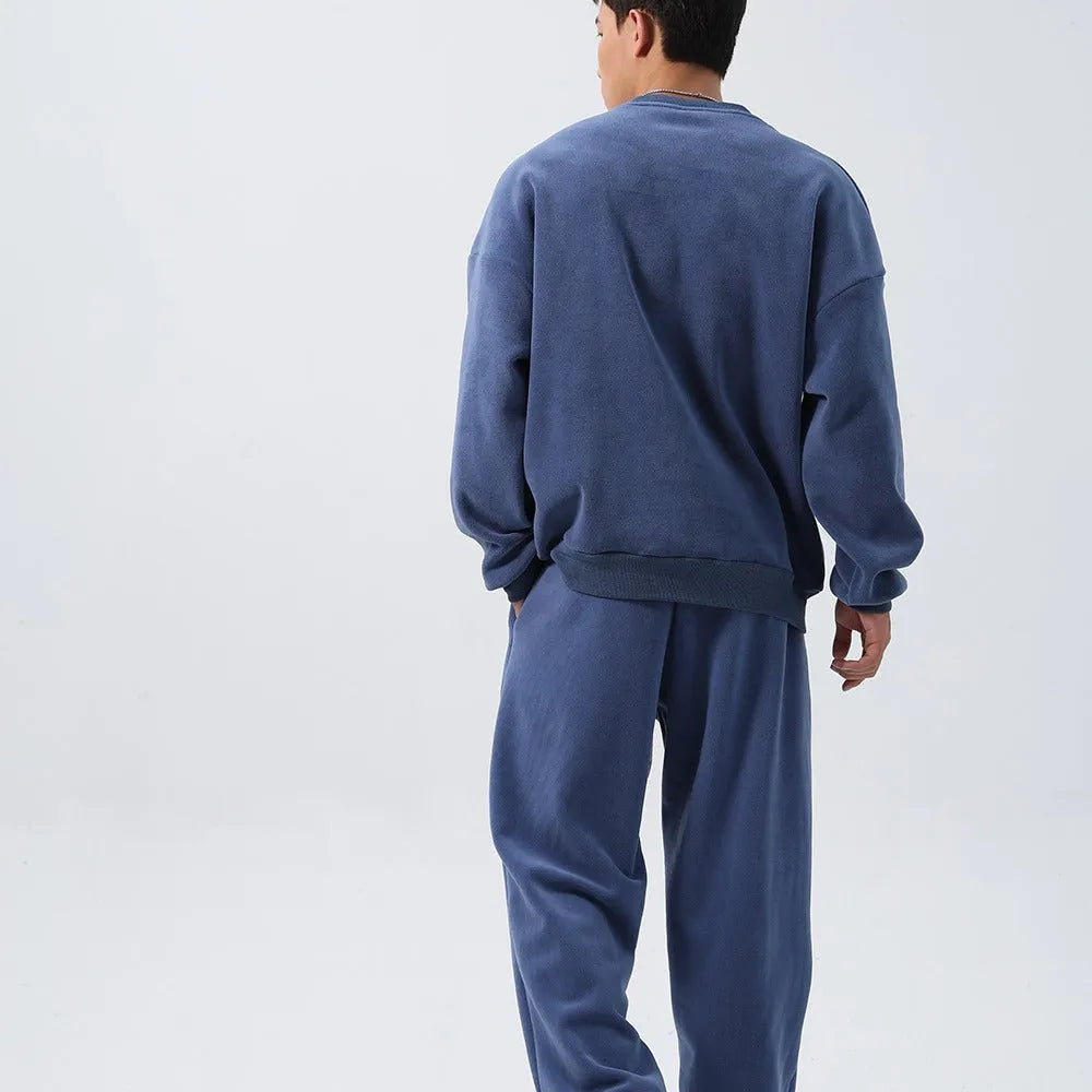 Men's polar fleece sports suit showing loose long sleeve coat and padded trousers in army green.
