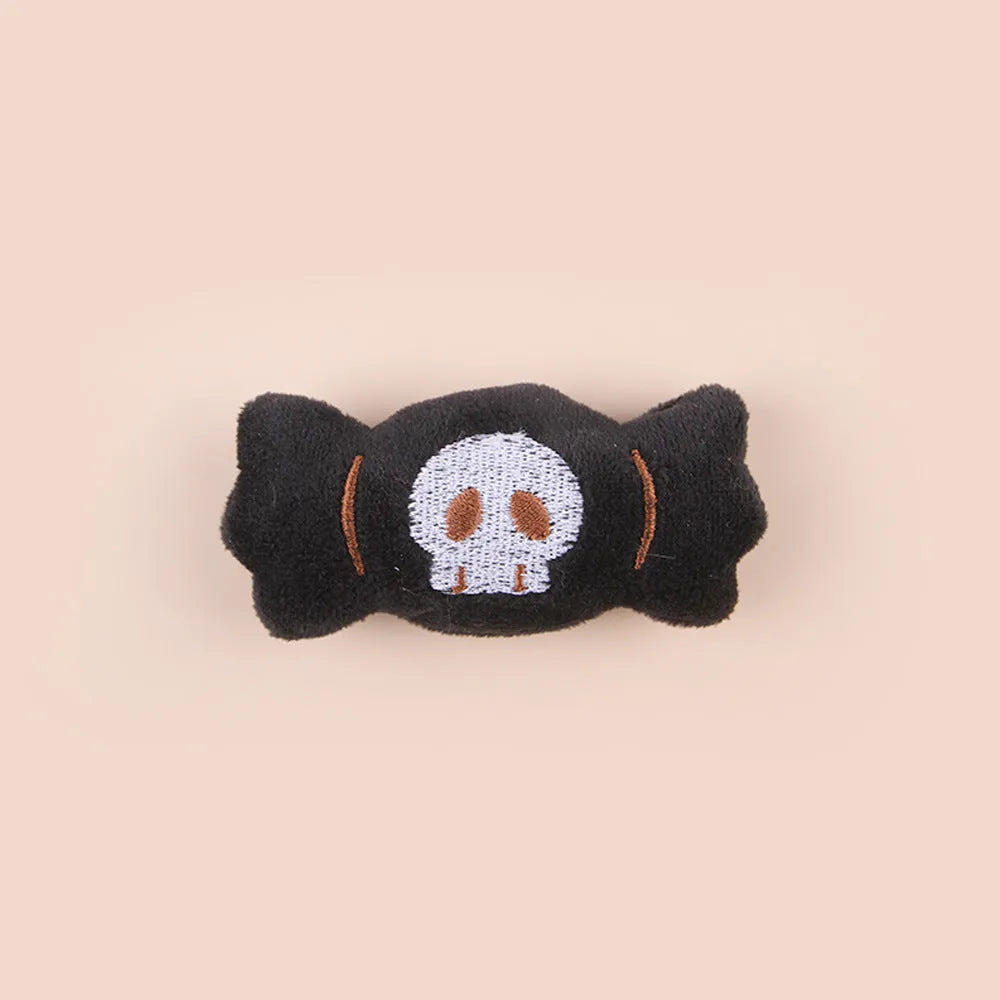 Small colourful plush cat teaser toy with candy, eyes and skull attachments