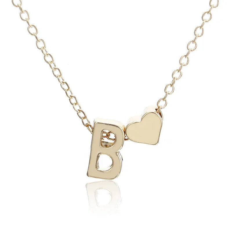 Peach-shaped heart letter pendant necklace on a chain in a gold or silver alloy finish.