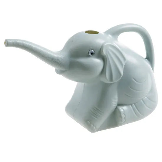 Pink baby elephant-shaped watering can with a long spout and baby bottle handle on a table.